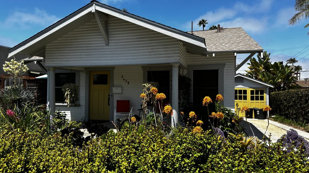 Craftsman bungalow in North Park San Diego with front porch, drought-tolerant landscaping, and detached garage on a sunny day